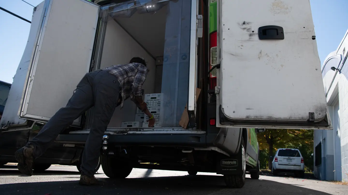 Loading produce boxes into a delivery van